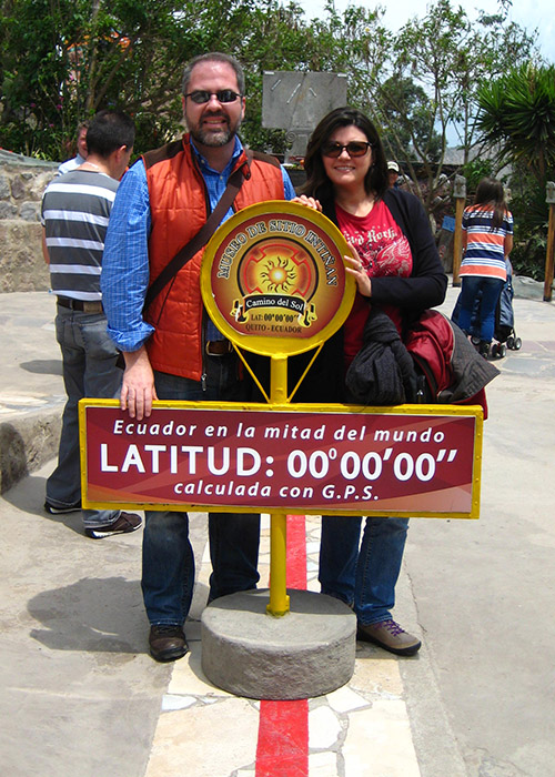 Andres and his wife, Veronica, standing in the north and south hemispheres in Ecuador