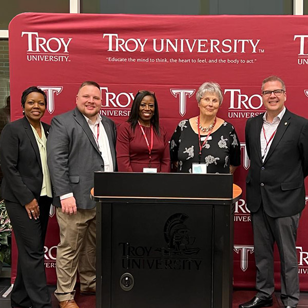 Andres Goyanes with fellow classmates and professors at Troy University